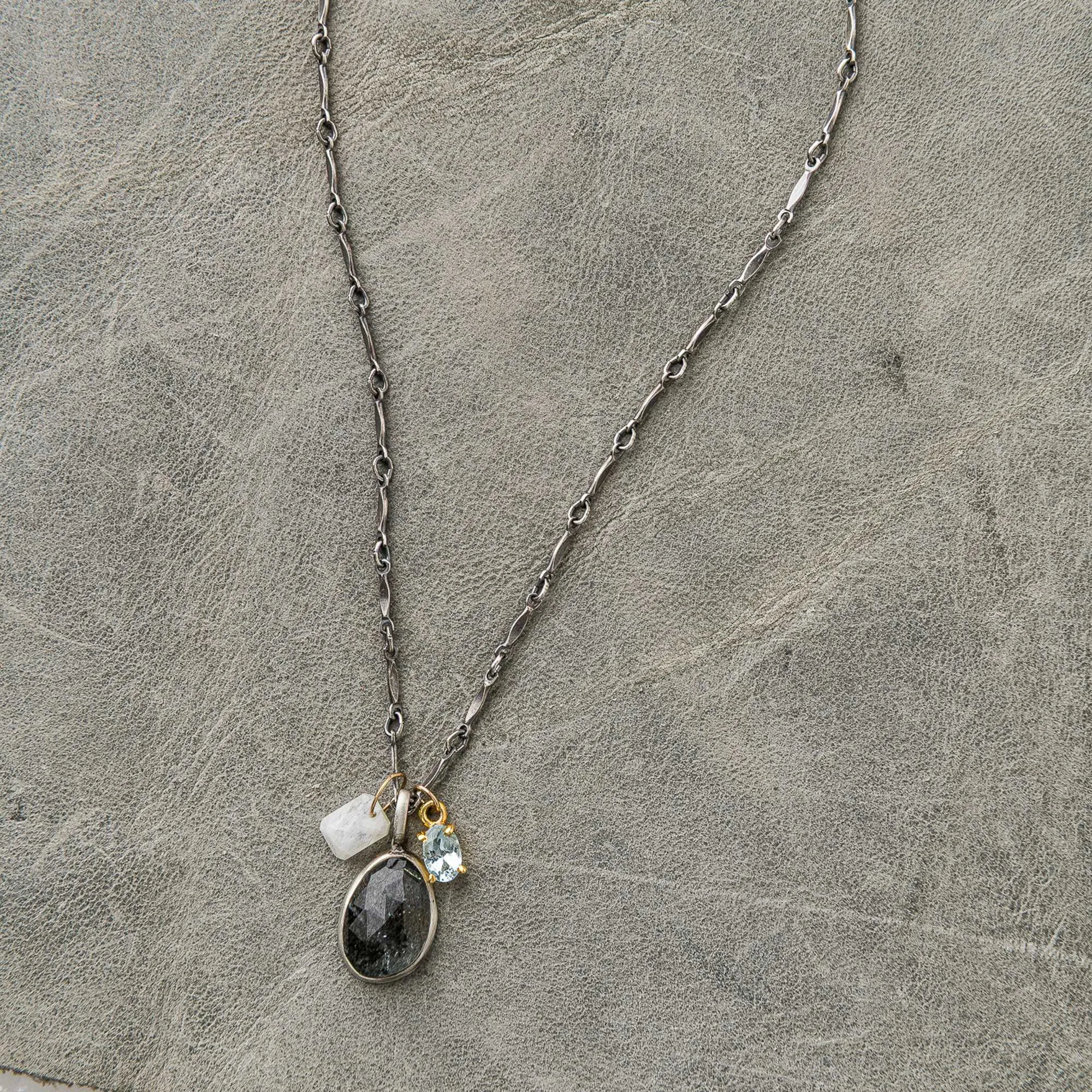 Moss aquamarine necklace with moonstone and topaz charms