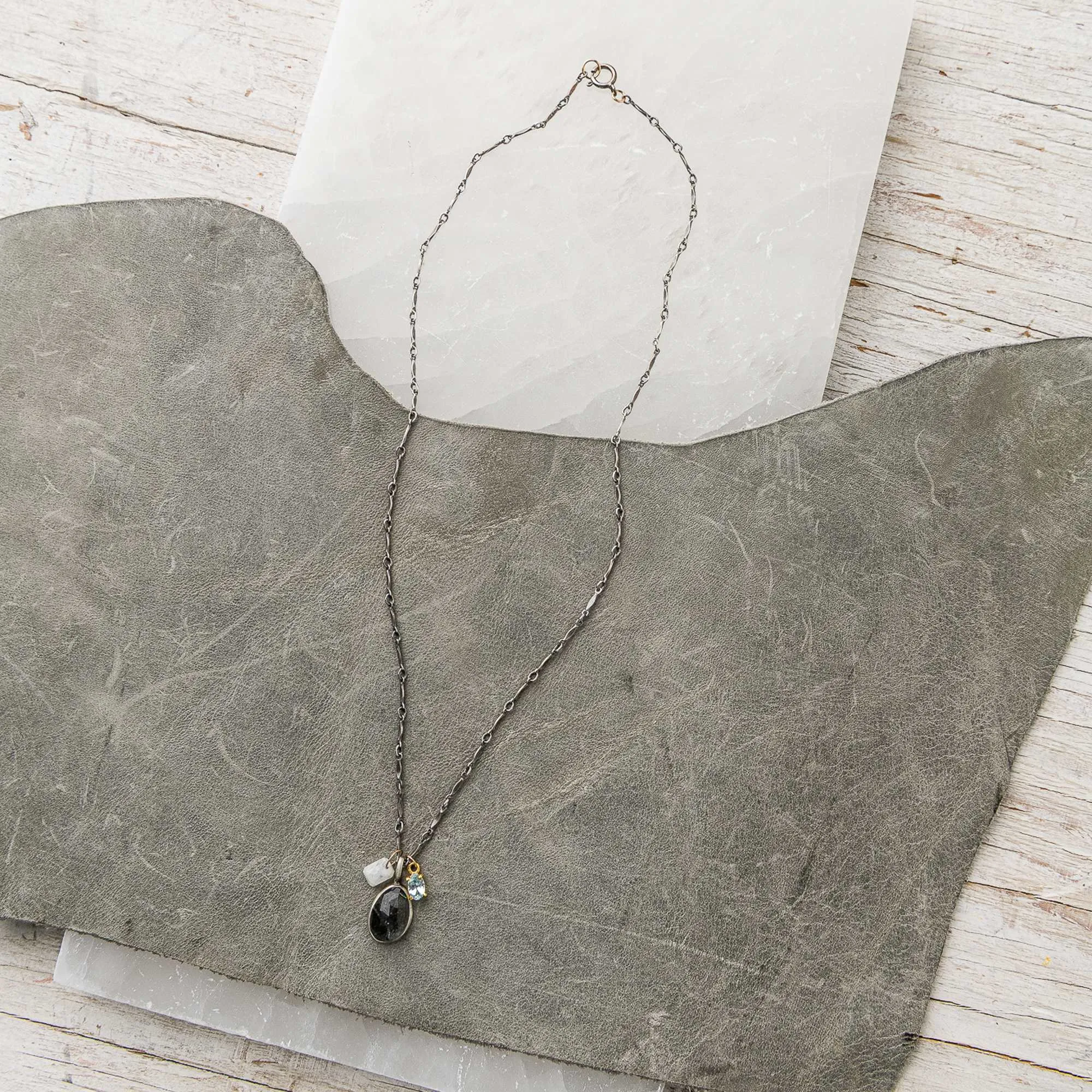 Moss aquamarine necklace with moonstone and topaz charms