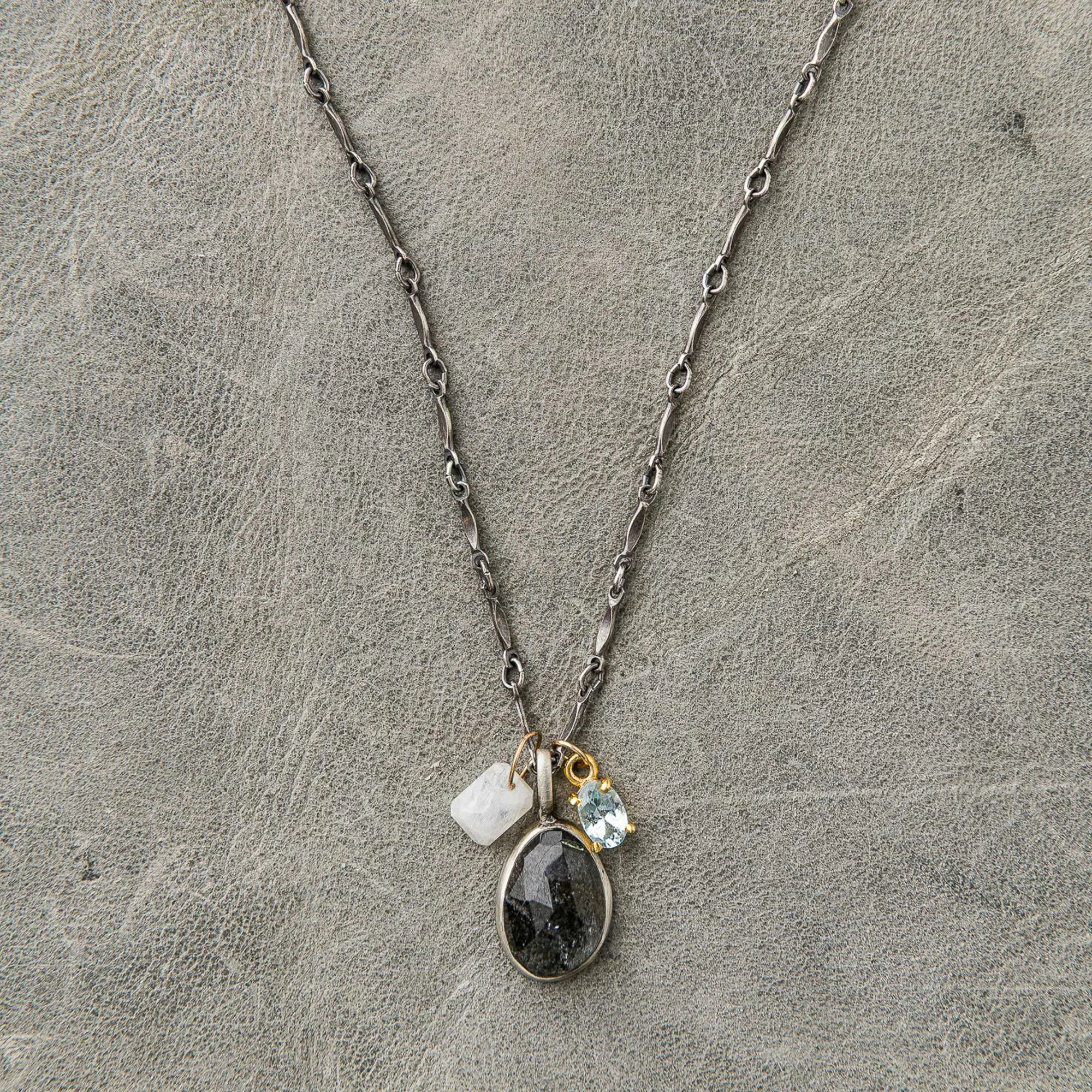 Moss aquamarine necklace with moonstone and topaz charms